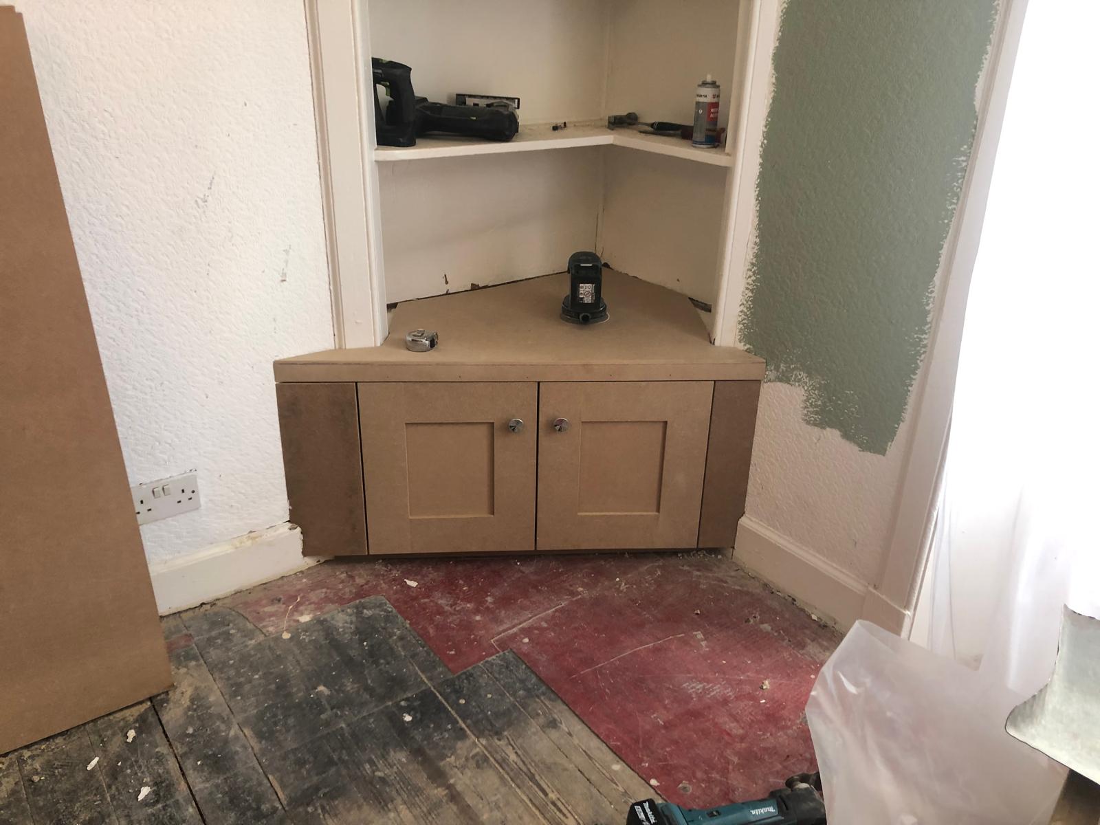 Custom corner TV unit under construction in the workshop, ahead of painting