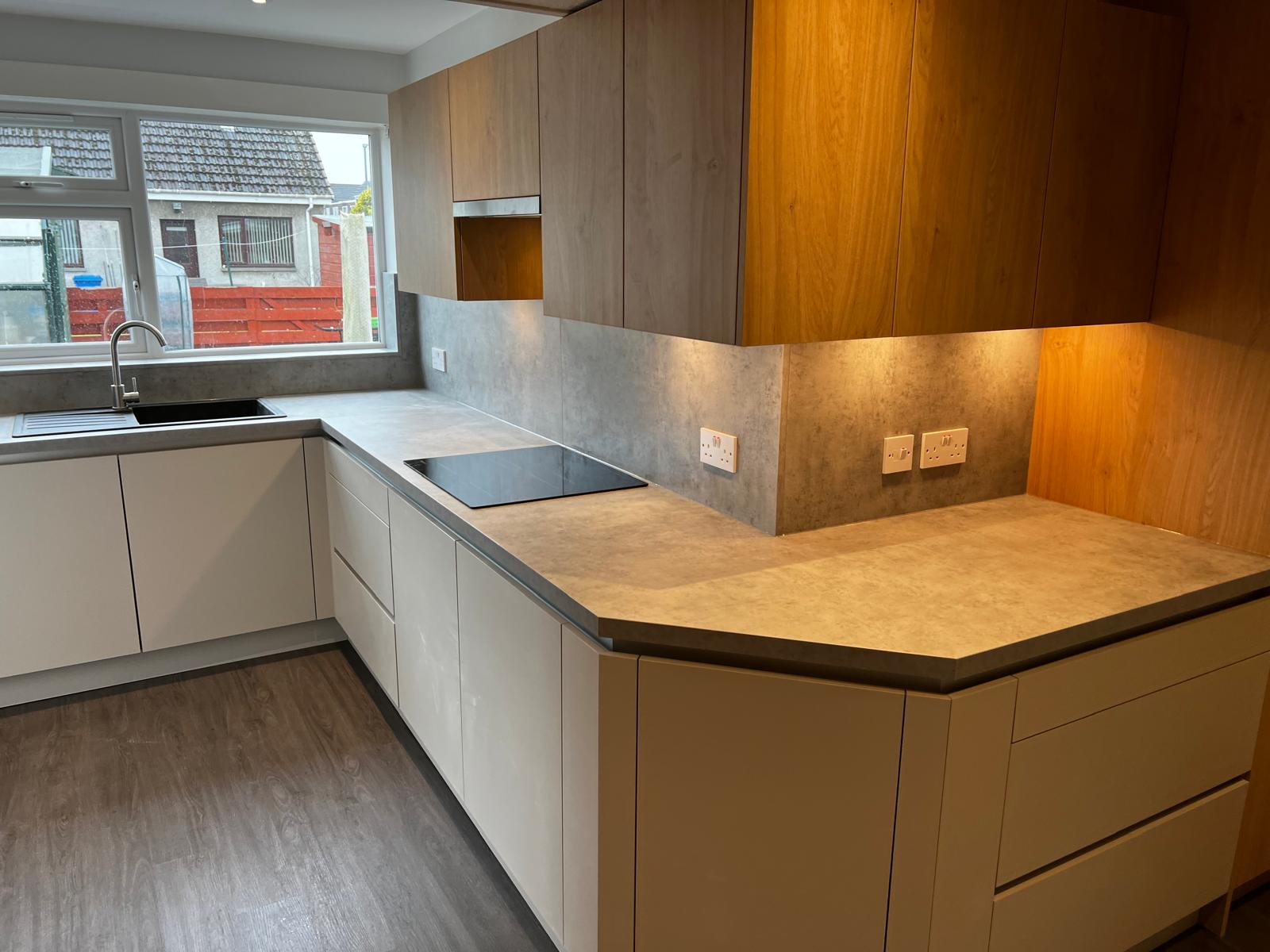 Contemporary oak kitchen with a concrete-effect worktop and integrated Miele oven